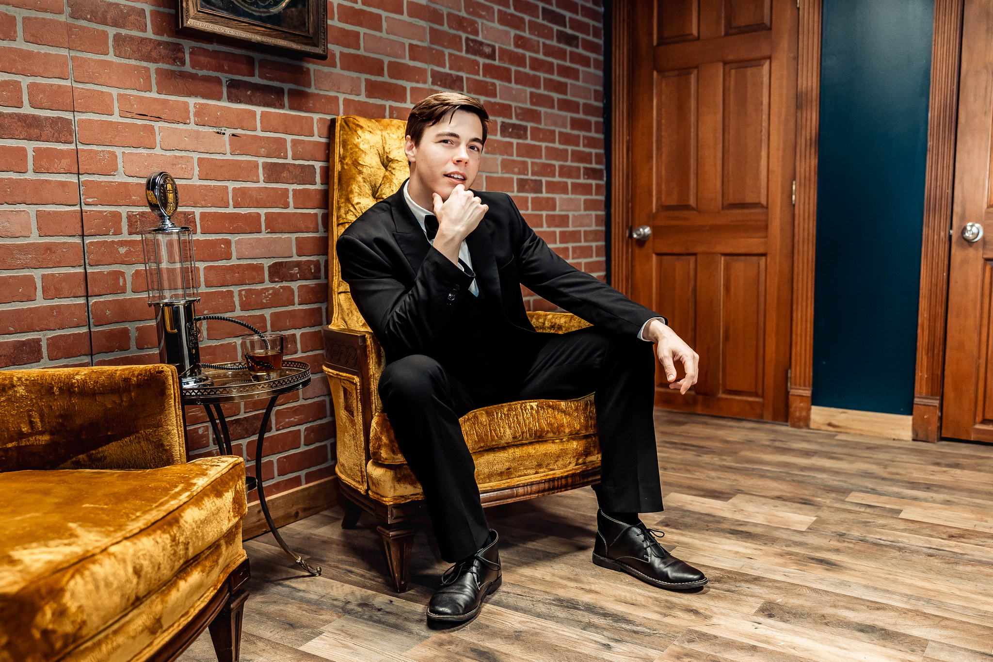 Groom sitting in chair looking thoughtful