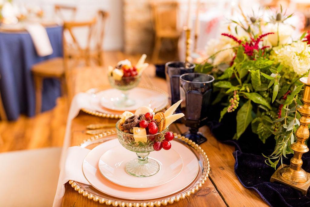 Fancy table placement with ornate glasses filled with luxury snack items at St. Louis Wedding Venues