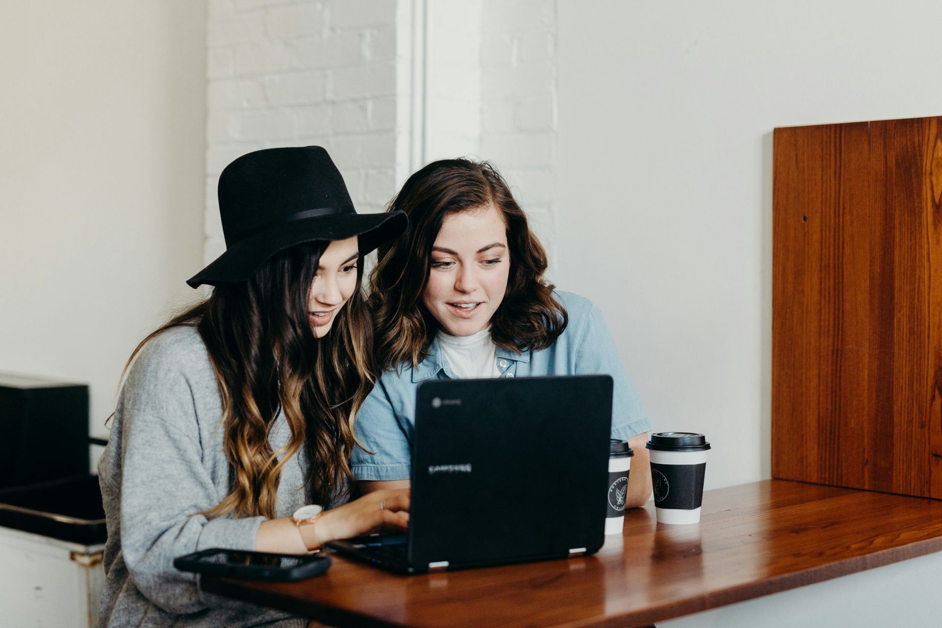 two women looking at a laptop