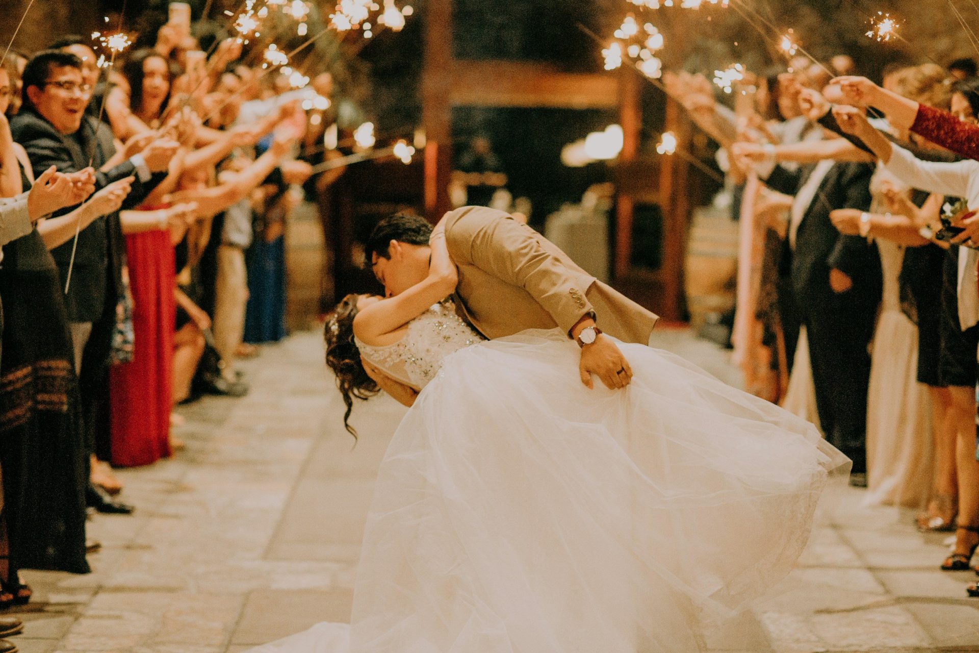 a man and woman kissing in front of a crowd of people